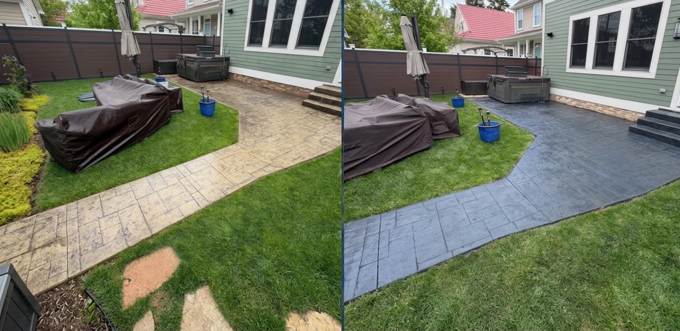 Dark gray stamped concrete patio beside a brick home