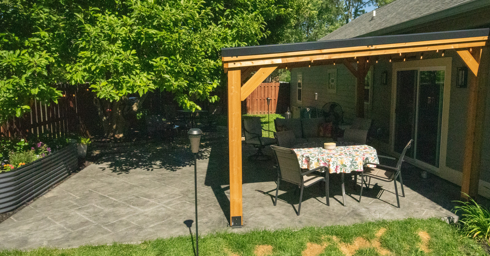 Finished broom-finished concrete patio with an outdoor dining area