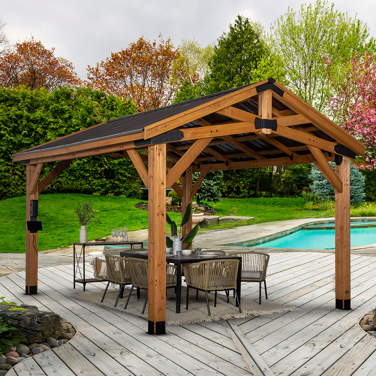12x14 cedar gazebo with a peaked metal roof over an outdoor patio