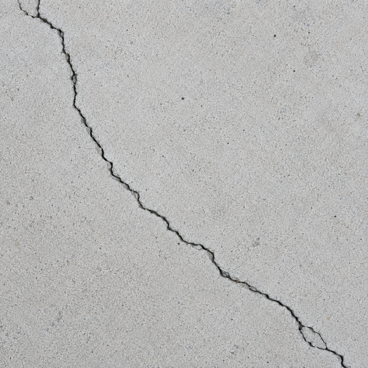 Cracked and uneven backyard concrete patio before replacement